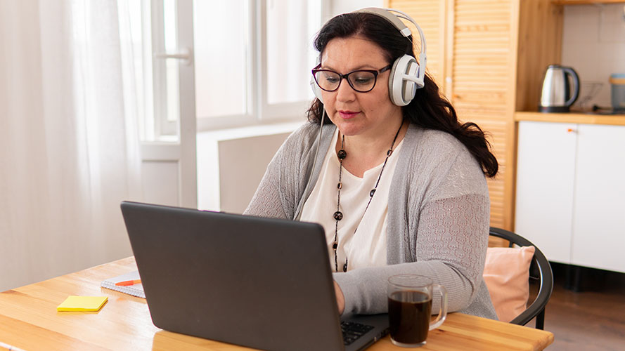 A woman wearing headphones and using SuperNova.